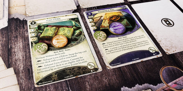 Arkham Horror LCG yellow 18 mm Exhausted token on a Seeker asset, showing that the Exhaust ability has been used. A purple 20 mm Exhausted token on a Mystic asset, showing that the Exhaust ability has been used.