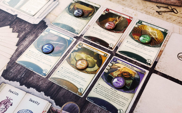 Arkham Horror LCG 20 mm Exhaust tokens in 6 colors; Black/Neutral, Red/Survivor, Green/Rogue, Blue/Guardian, Yellow/Seeker and Purple/Mystic on class cards with a exhaust ability.