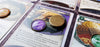 Arkham Horror LCG 20 mm purple/Mystic Exhausted token and another token flipped over to show the brass metal backing of the token.