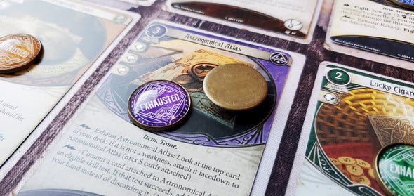 Arkham Horror LCG 20 mm purple/Mystic Exhausted token and another token flipped over to show the brass metal backing of the token.